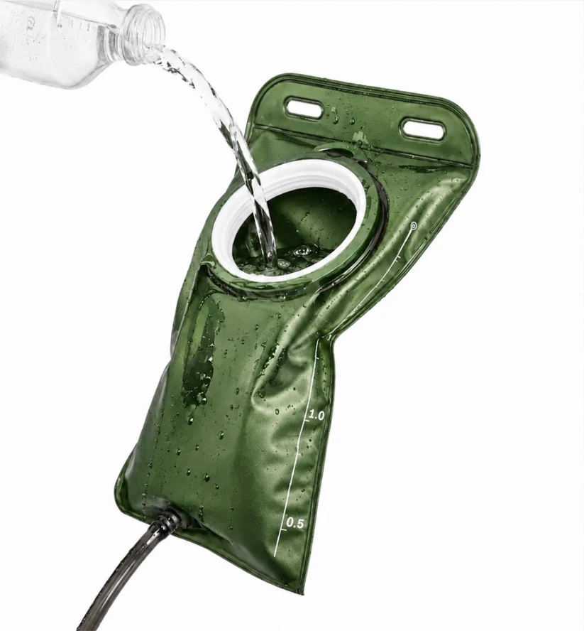 1.5L CoreFlow hydration bladder in green being filled through the wide cap